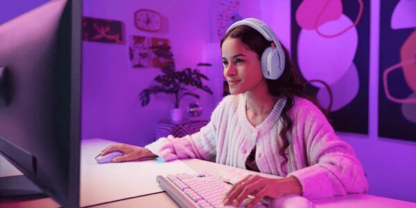 Auriculares inalámbricos Logitech G325 en color lila utilizados por una jugadora en un set de gaming